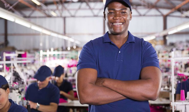 Smiling man in a clothing factory