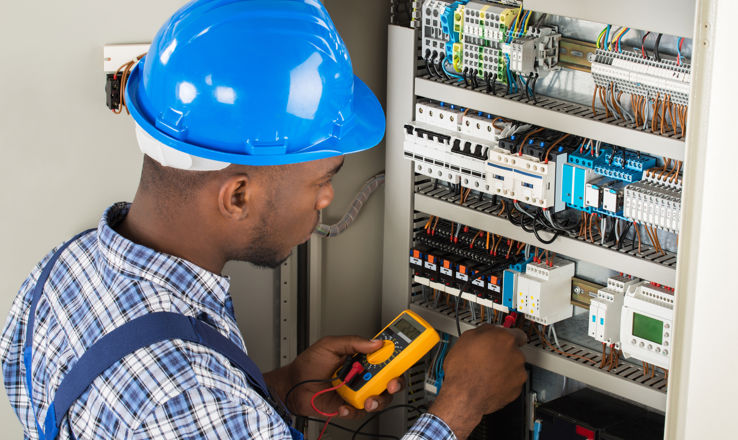 Electrician working on a power panel