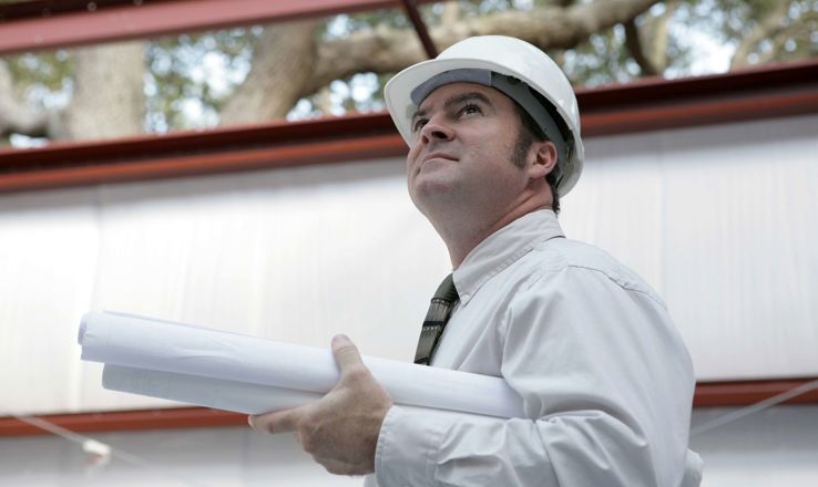 Construction worker holding plans